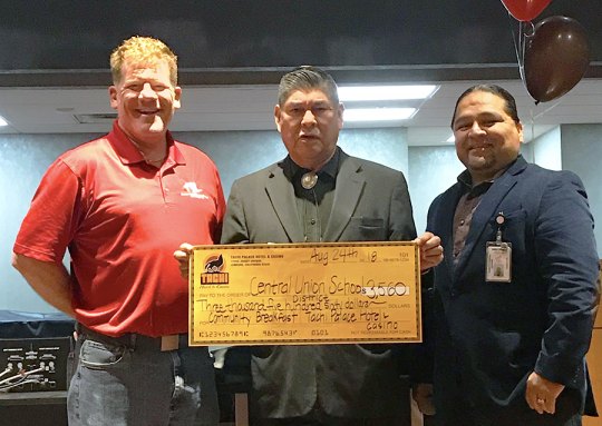 Tachi Palace Hotel and Casino Assistant General Manager Bill Davis and Marketing Director Tribal Intern Rojelio Morales present Superintendent Tom Addington with a $5,000 check.